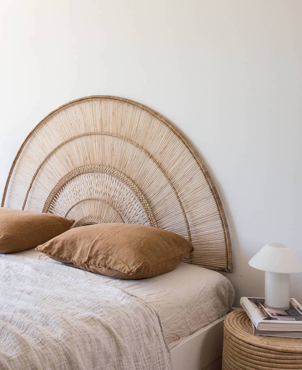 a boho bedroom with a natural wood sun-inspired bed frame