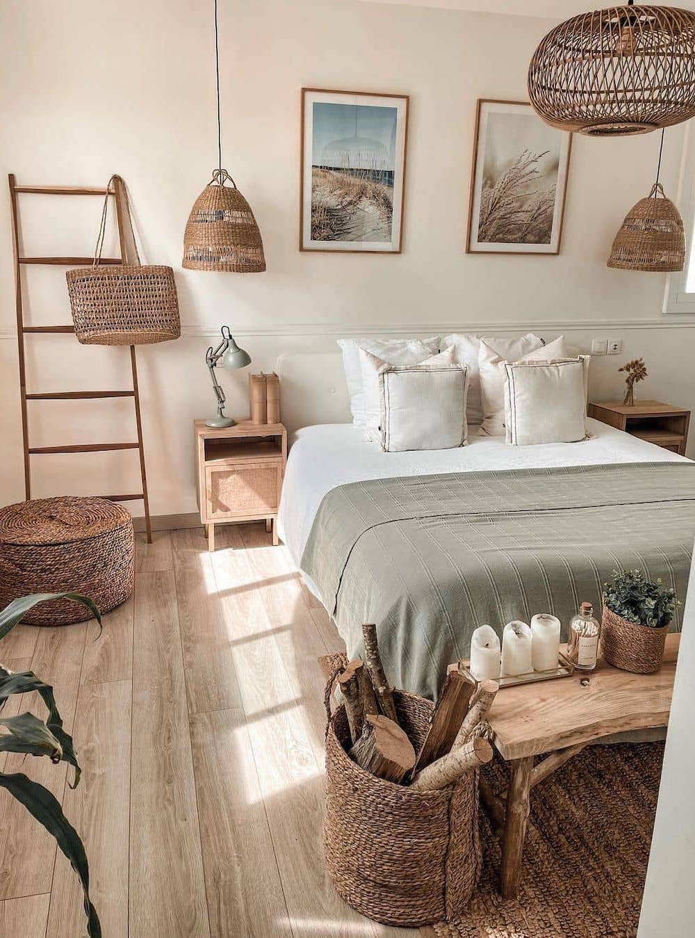a coastal boho bedroom with woven baskets, natural wood furniture, ocean-inspired wall art and soft earthy tones