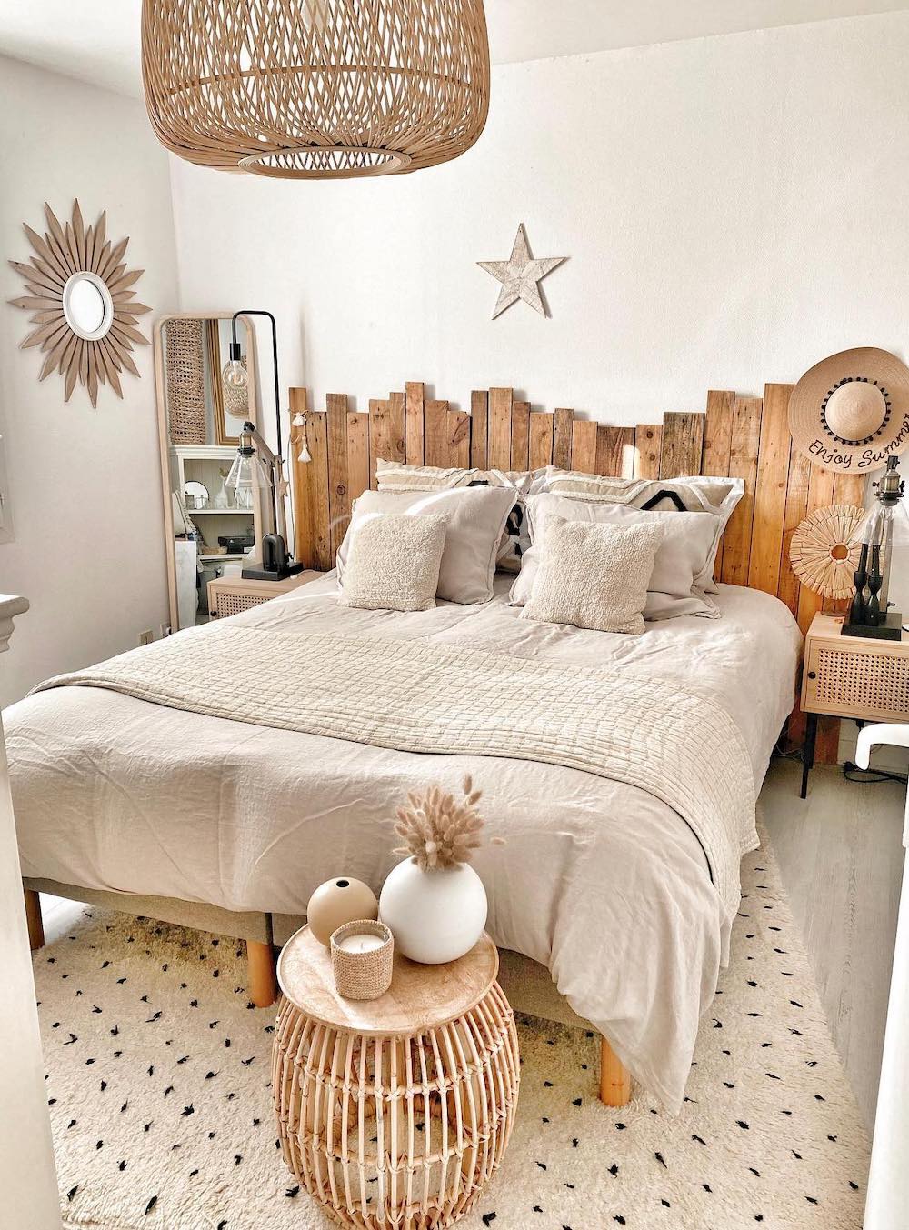 a rustic bohemian style bedroom with a reclaimed wood headboard and other natural elements