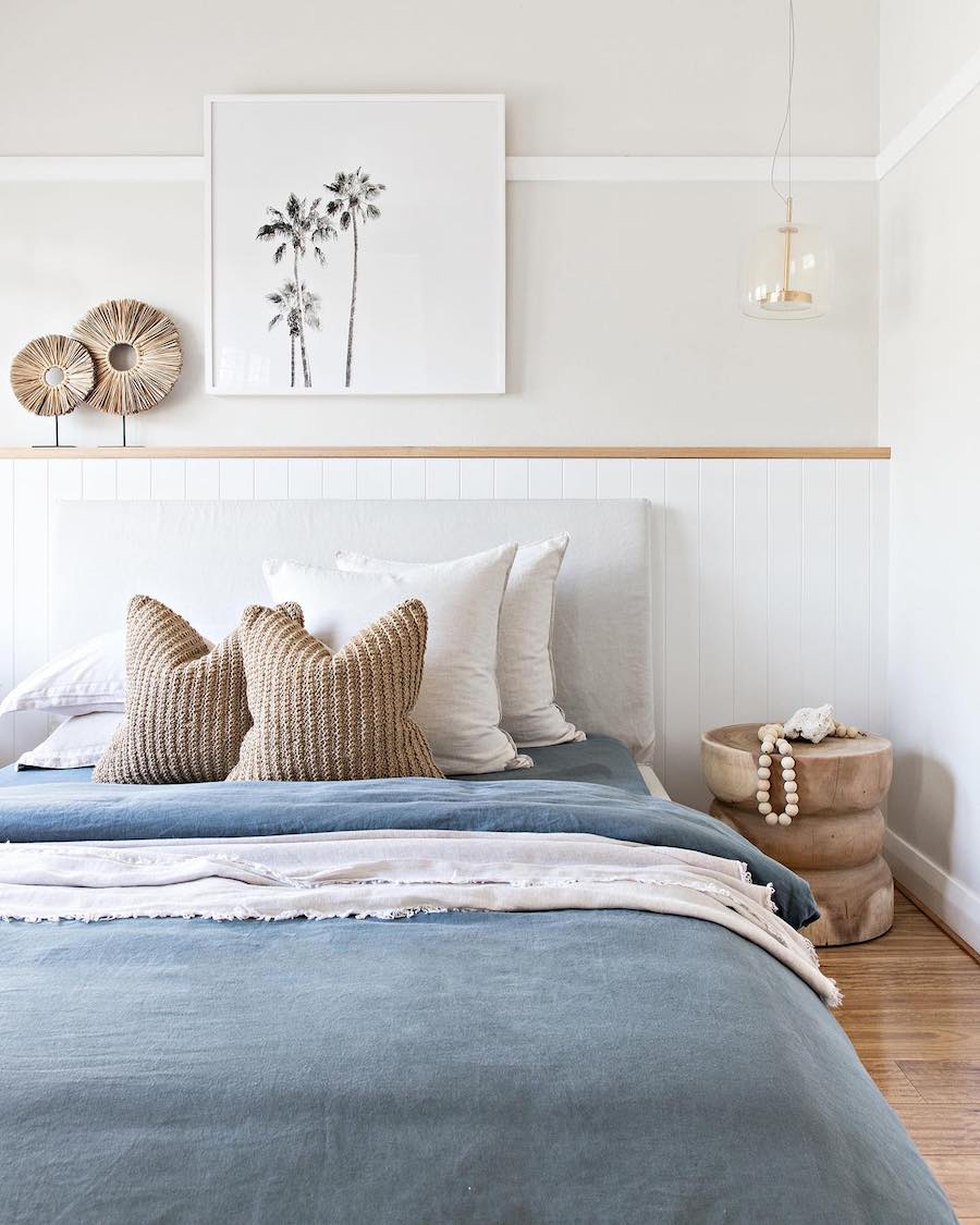 a blue, beige, and white coastal bedroom with natural elements