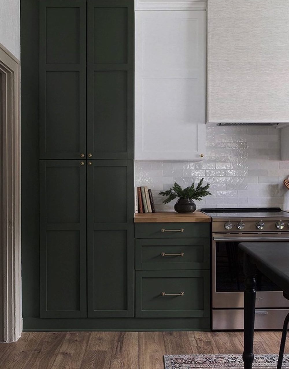 a dark green and white kitchen with pieces from Ikea