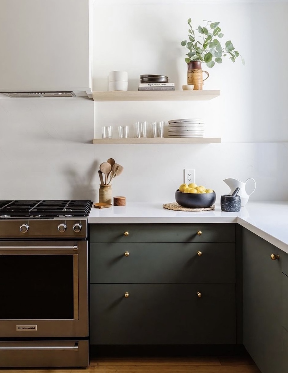 a white and dark green kitchen with pieces from Ikea