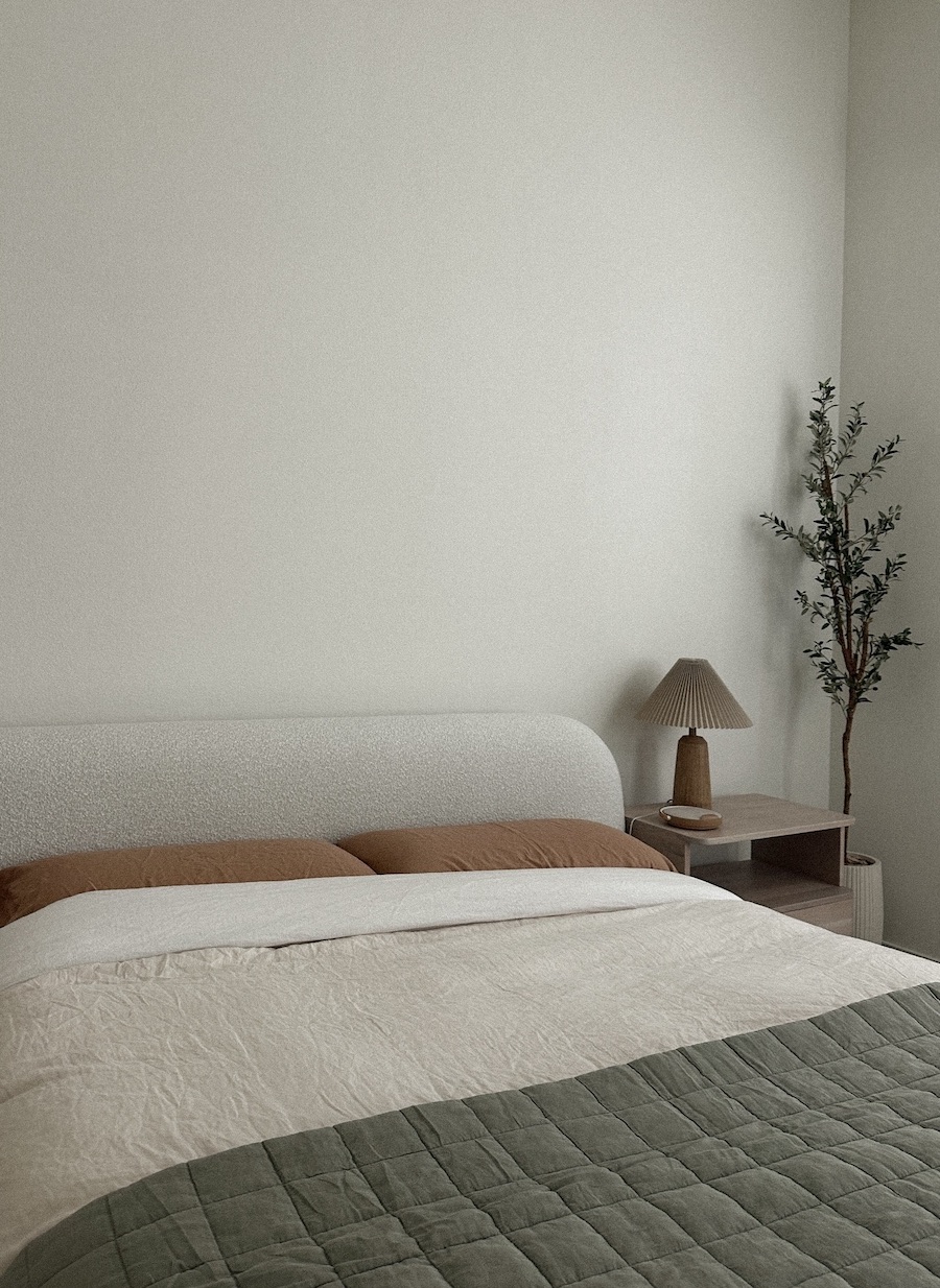 a minimalist bedroom featuring earthy tones and plush linens
