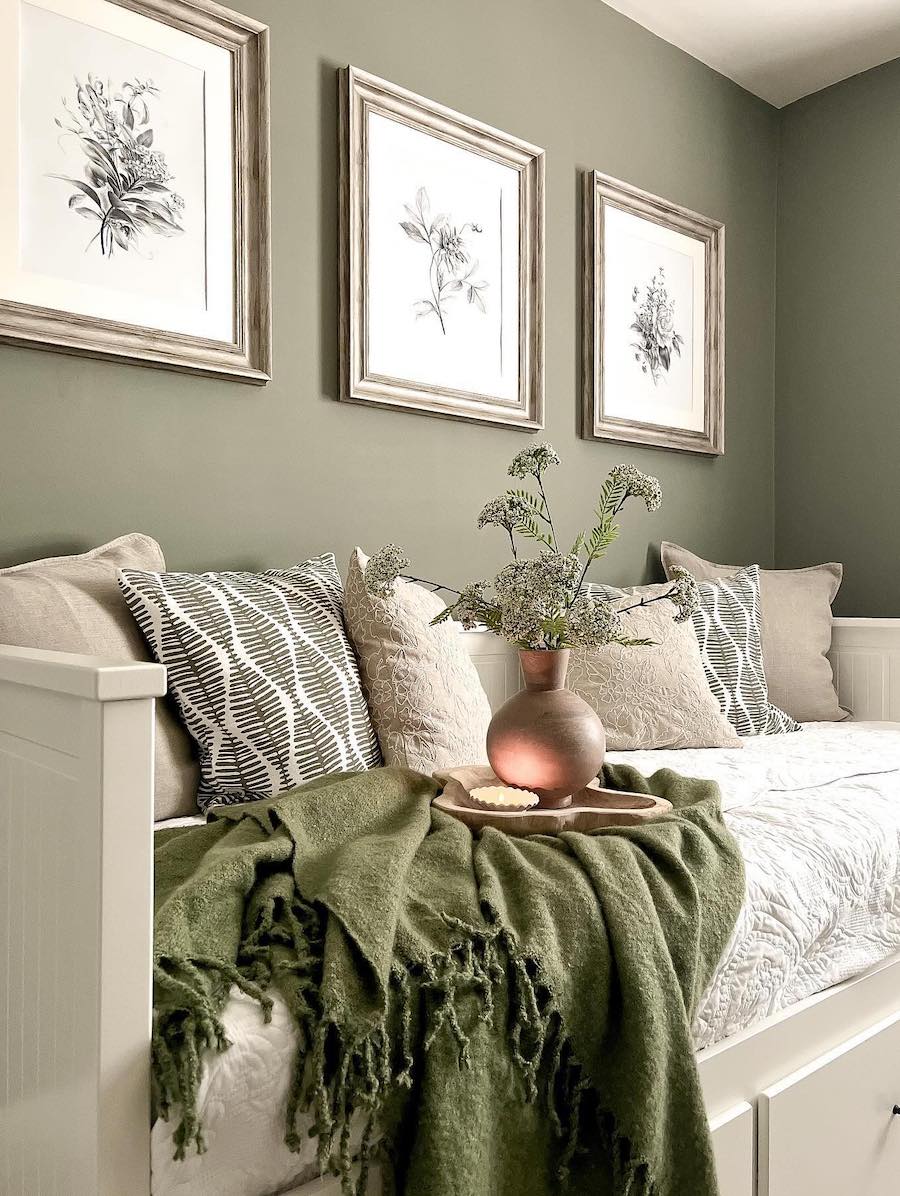 a beige and sage green bedroom featuring floral decor and a stylish daybed
