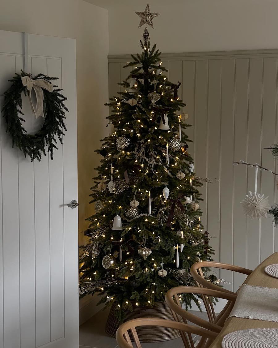 a christmas tree with ornaments, bells, and lights