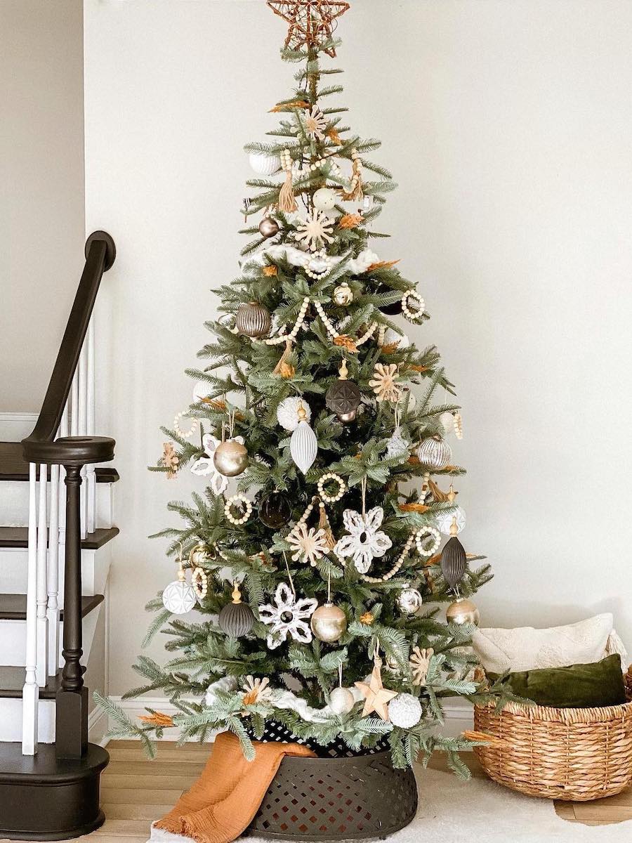 a christmas tree with black, white, and beige ornaments