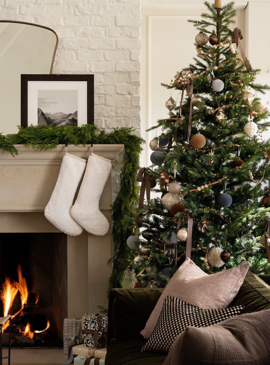 a christmas tree with vintage decorations in white, navy, and camel