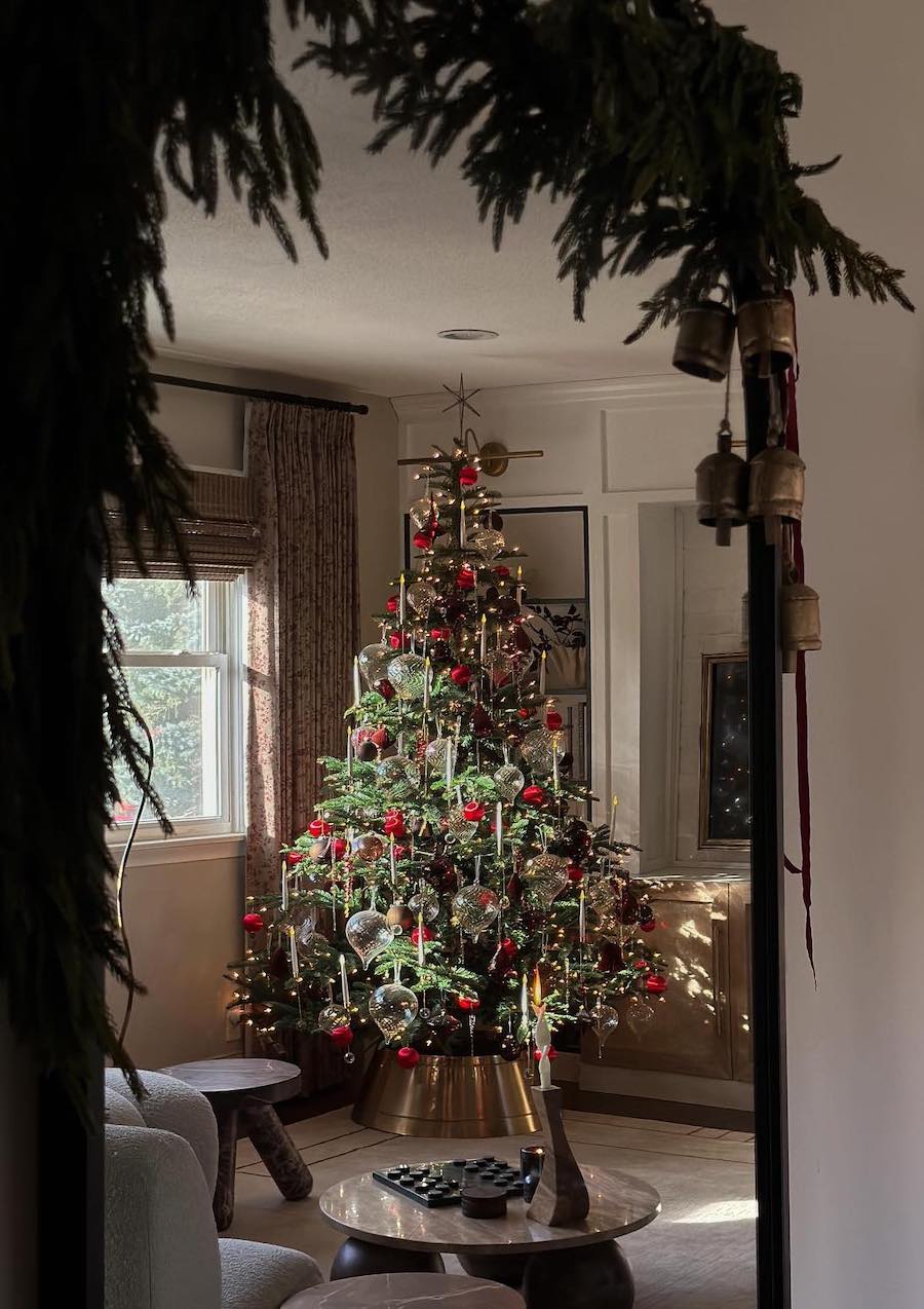 a christmas tree with red and clear ornaments and golden lights