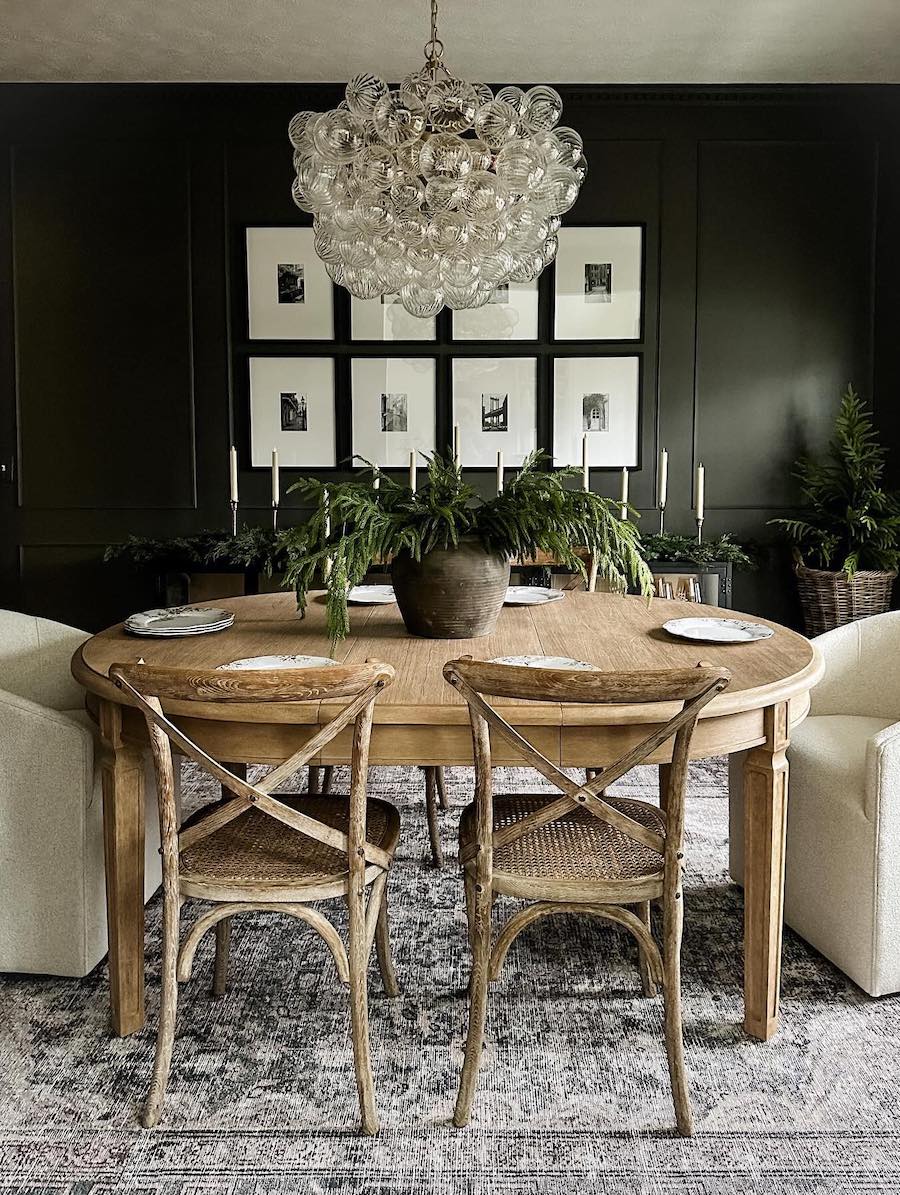 a dining table with pine decor and ivory candles