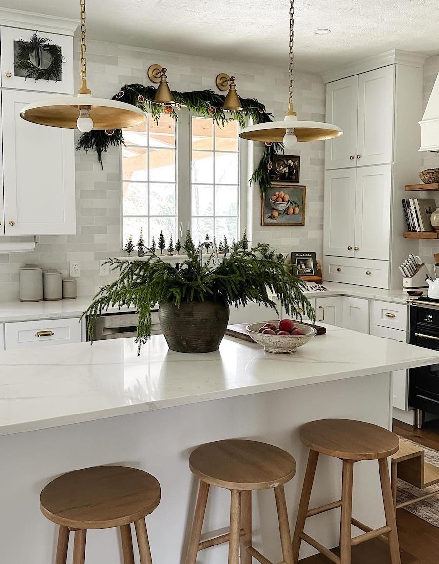 a kitchen with pine decor and orange garland