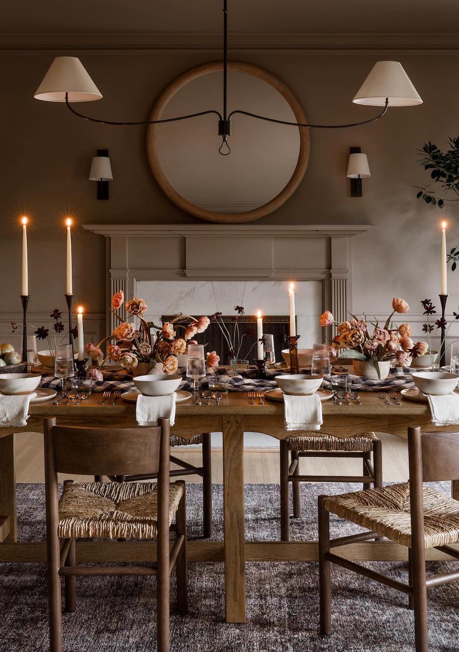 a dining table with a fall-inspired centerpiece featuring fall florals, candles, and plaid prints