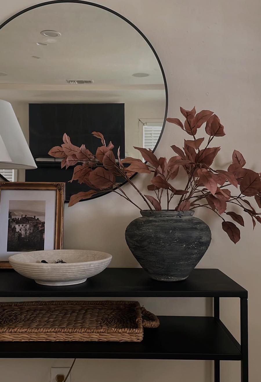 a fall leaf bouquet on an entryway table