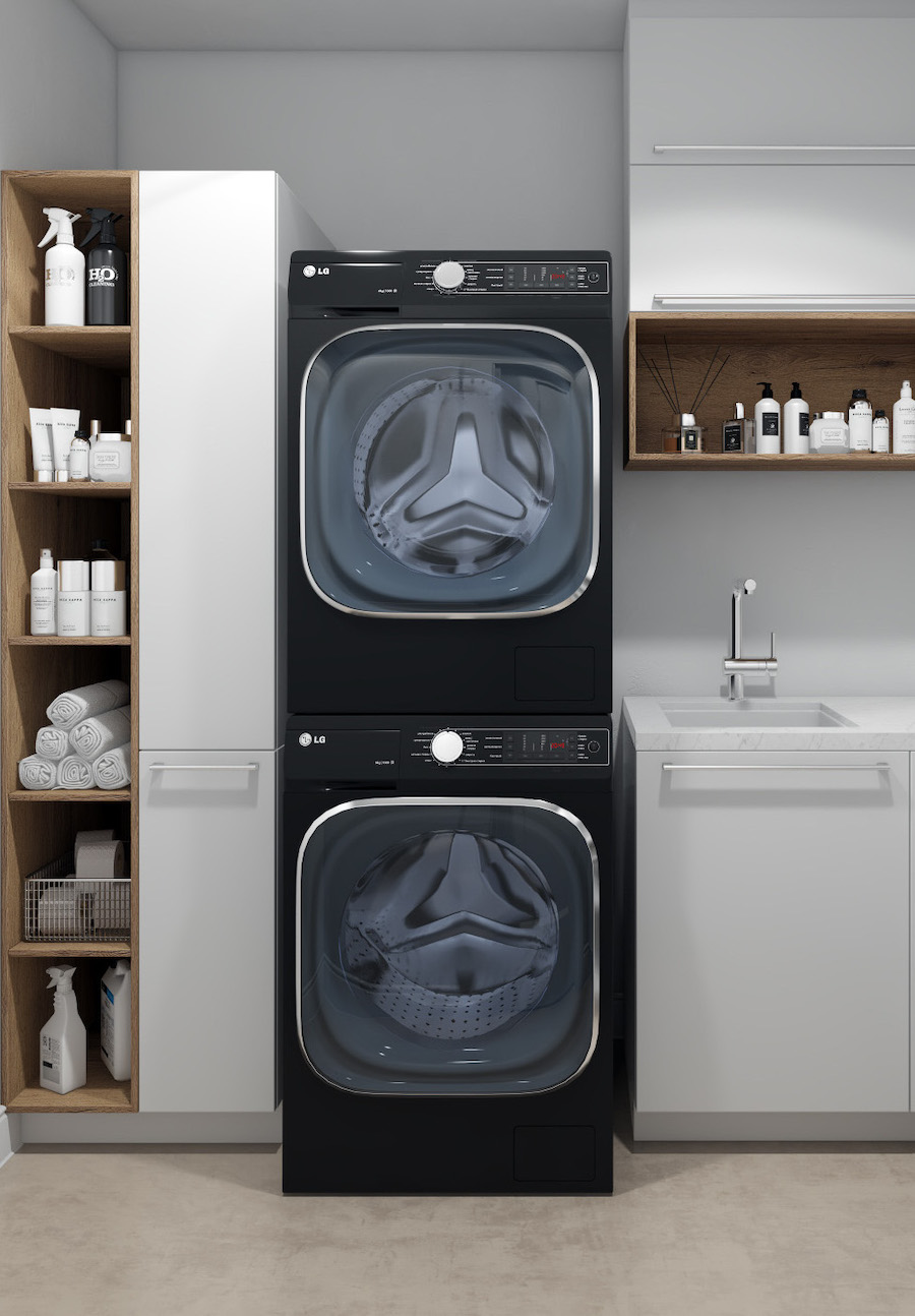 a laundry room with stacked machines, a built-in sink and plenty of storage