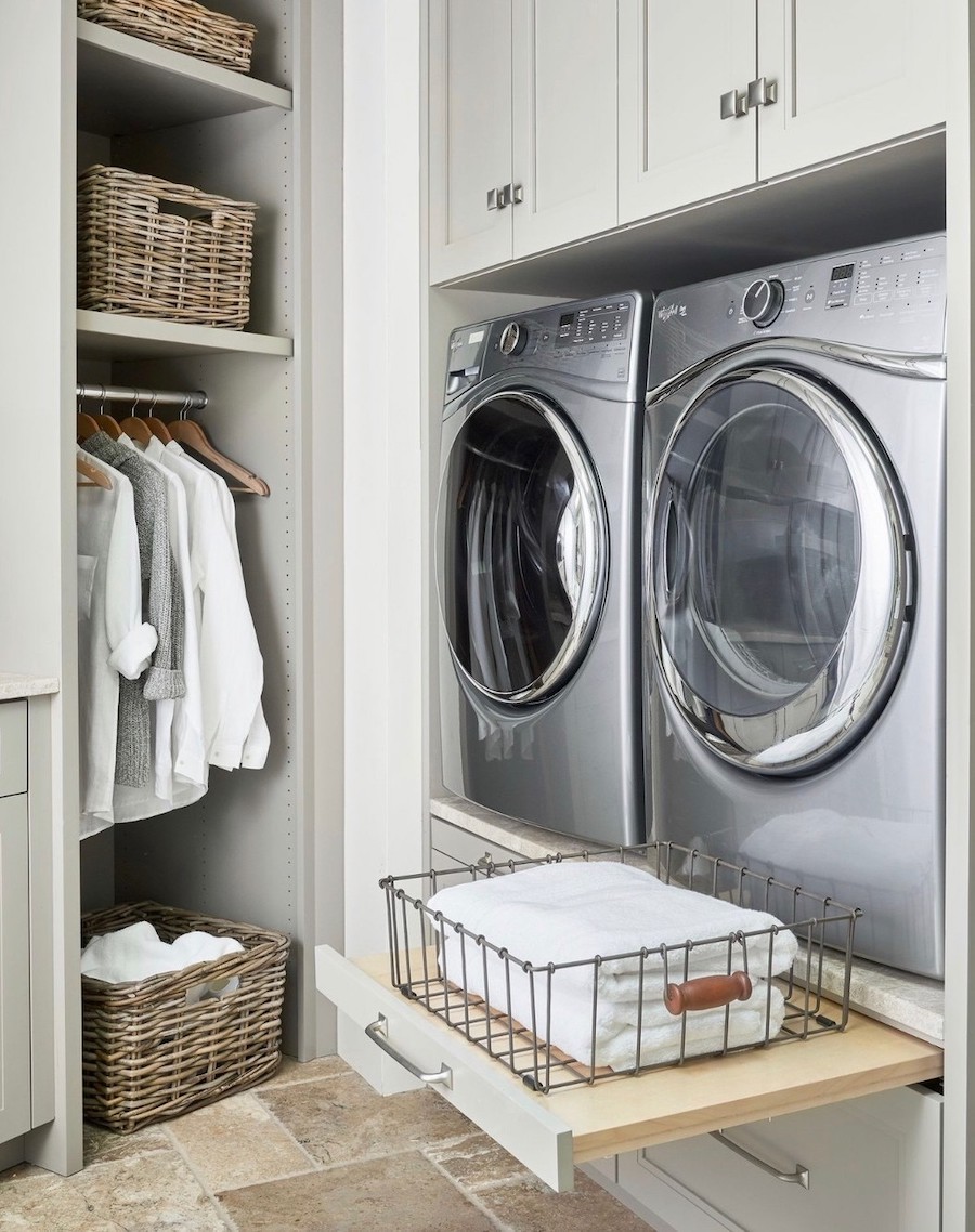 a laundry room with shelving and pull out counters