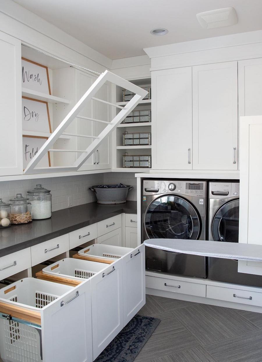 a laundry room with a pull down drying rack, pull out basket drawers, and countertop storage