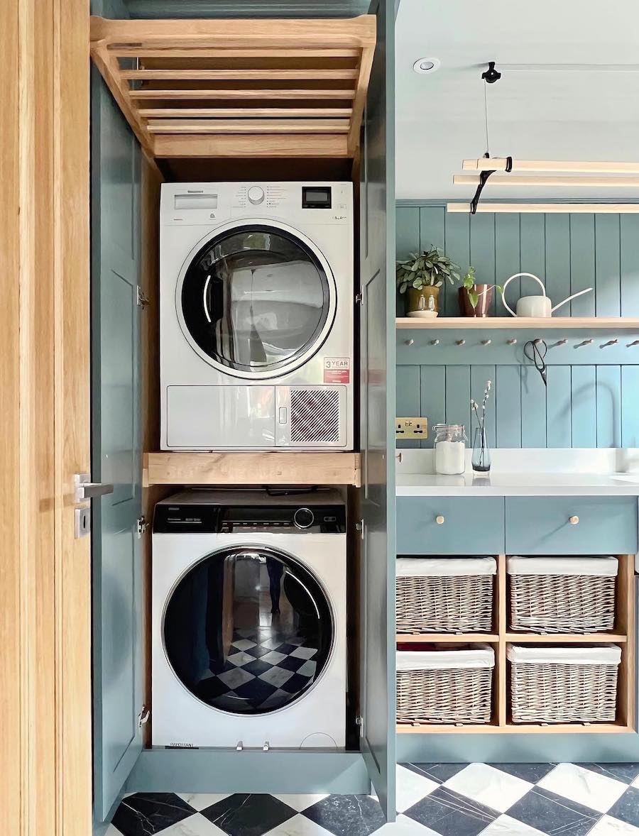 a laundry room with pull out baskets and a pull down drying rack