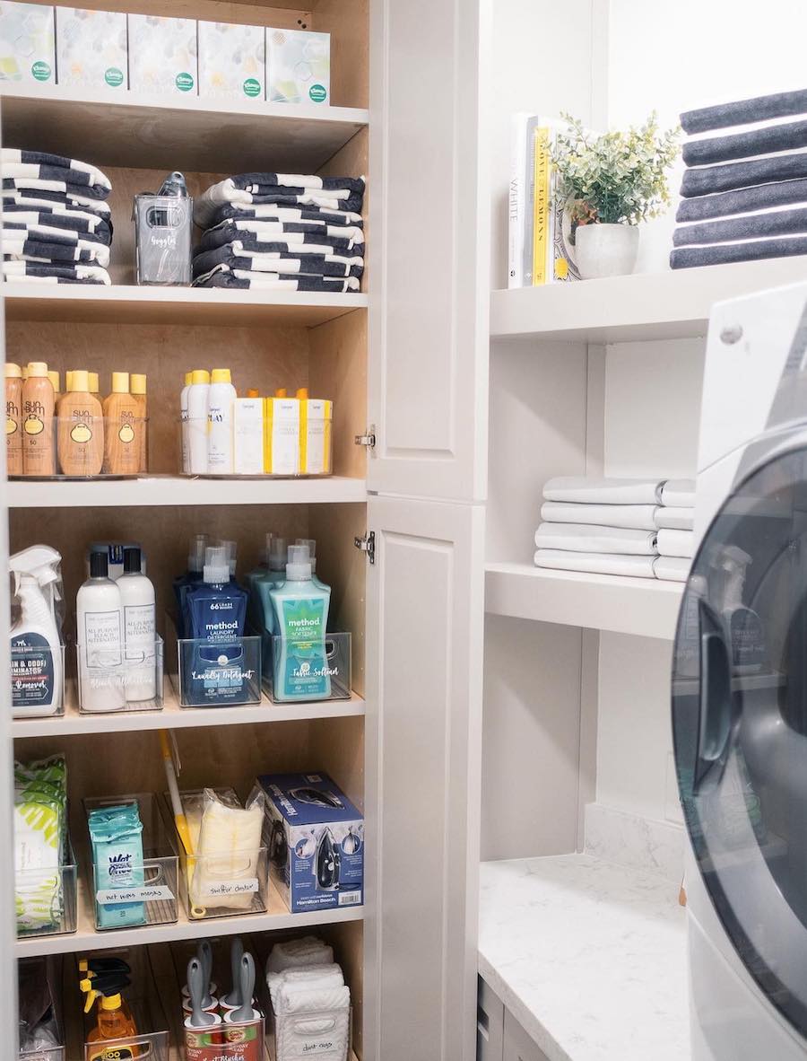 laundry room organization featuring open shelving and cabinets