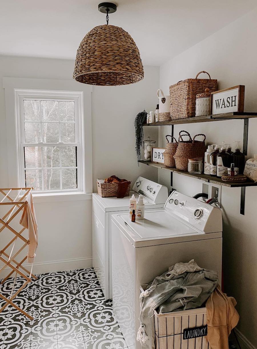 laundry room organization featuring open shelves above the machines