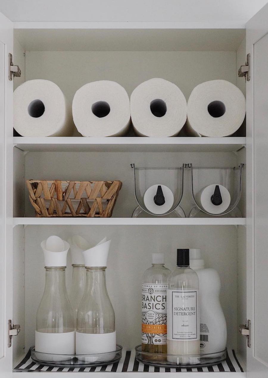 a laundry room shelf with laundry essentials, paper towels, and other laundry room organization