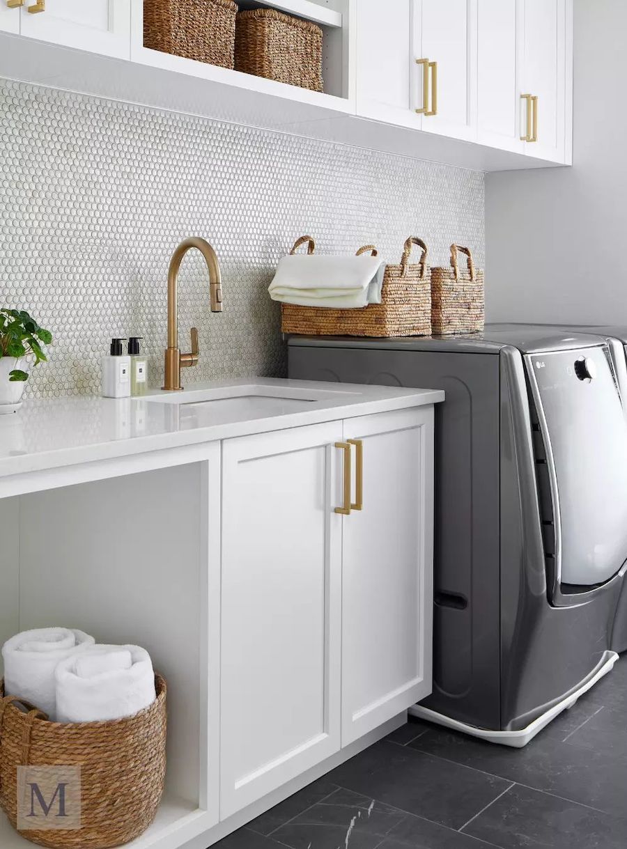 a laundry room with cabinets and a countertop with a sink