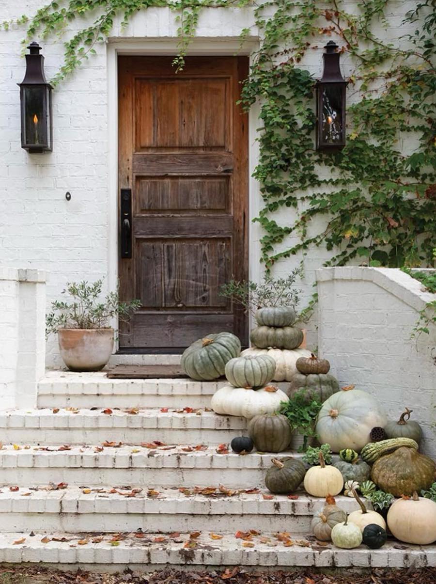 a front porch with rustic charm and pumpkins and squash