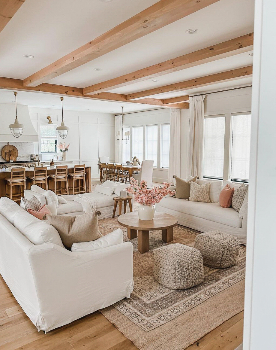 a bohemian living room featuring wood beams and other natural wood