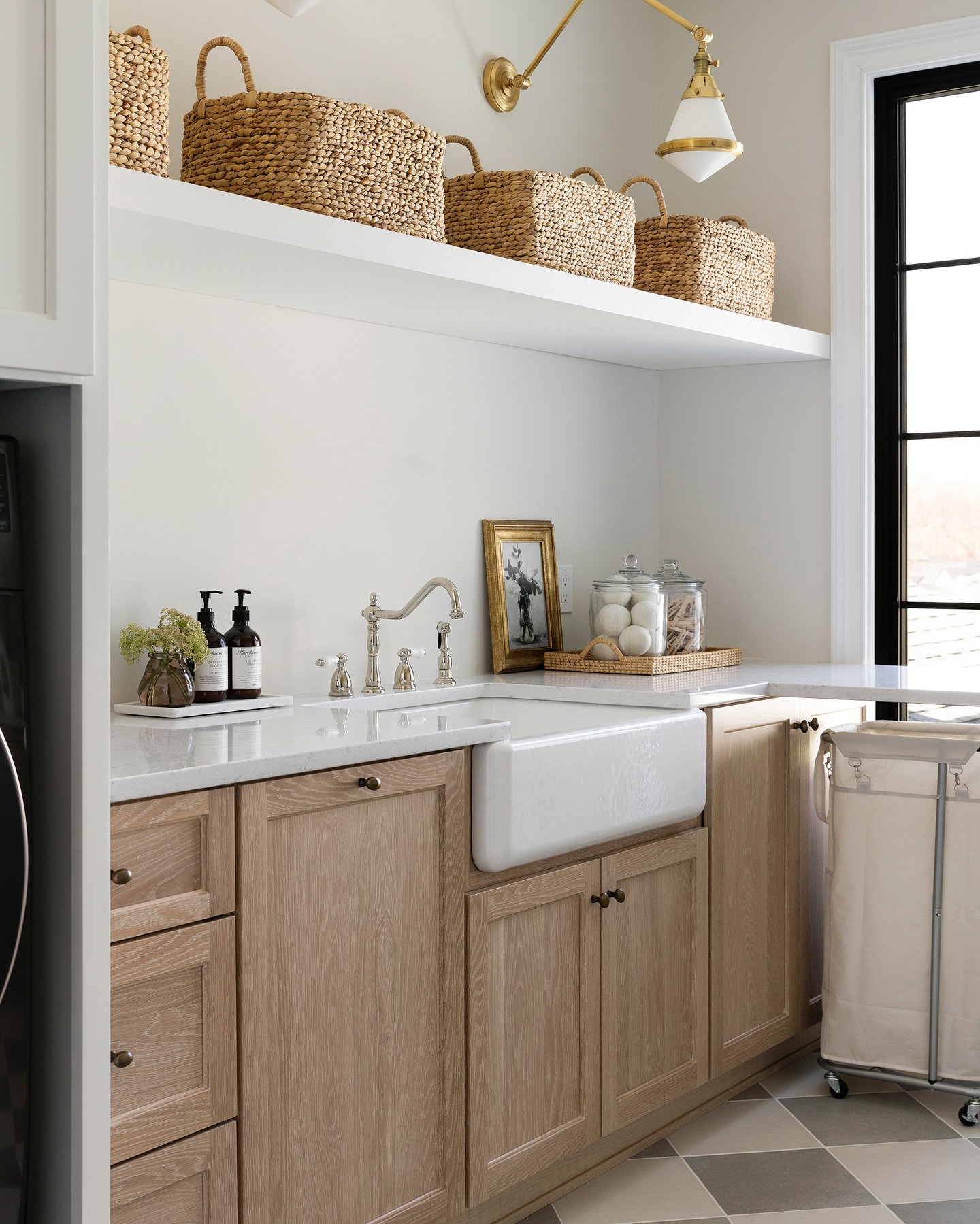 a cottage style laundry room with white and beige tones