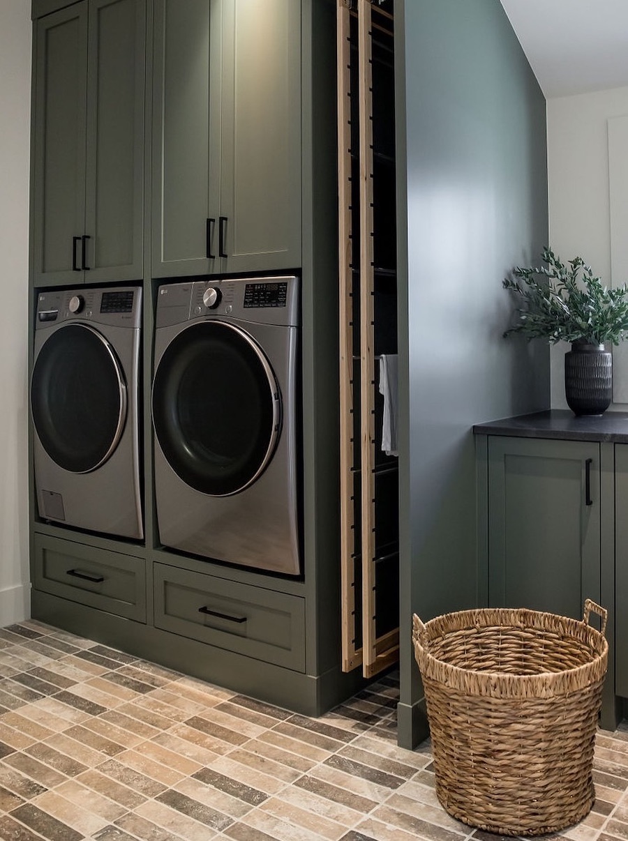 a small laundry room with pull out drying racks