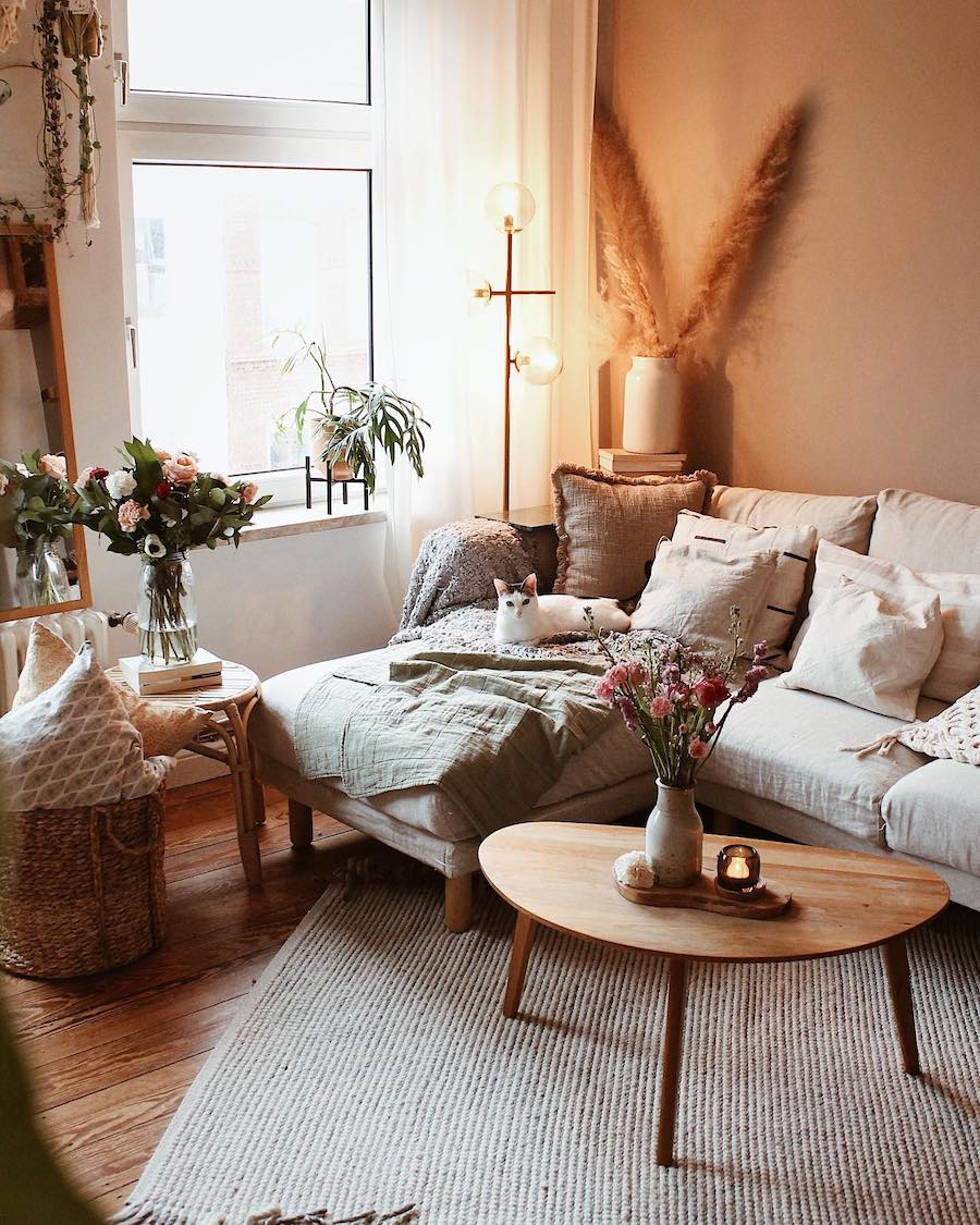 a bohemian living room featuring floral decor and classic boho accents