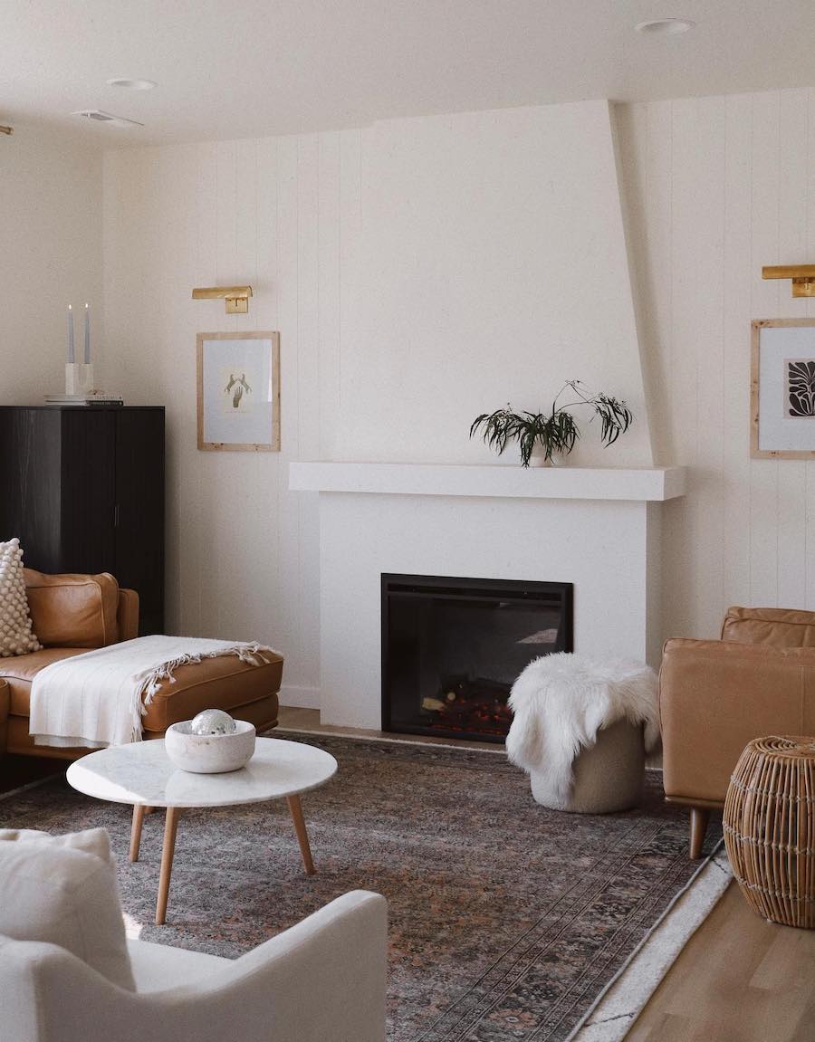 a bohemian living room featuring white, black, and camel tones