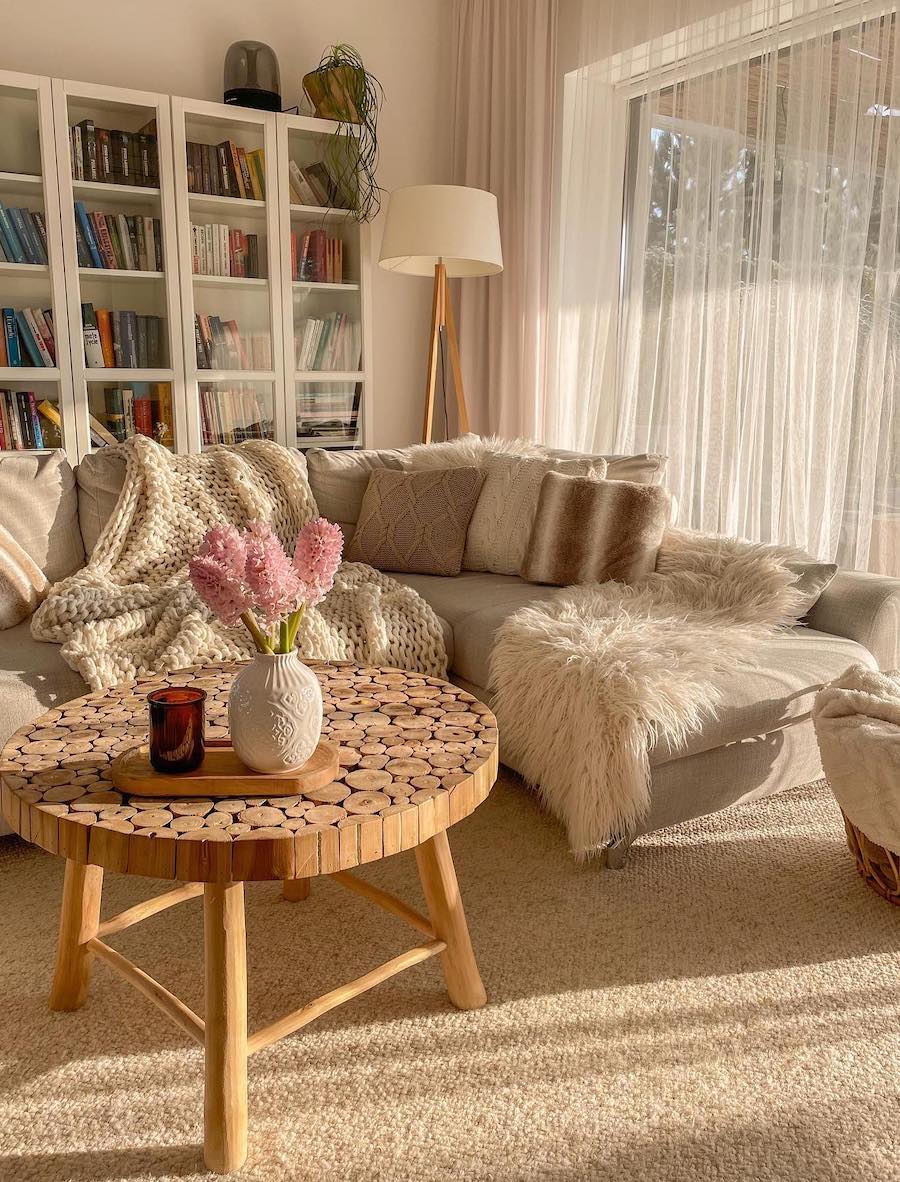 a bohemian living room featuring cozy pieces and nude tones