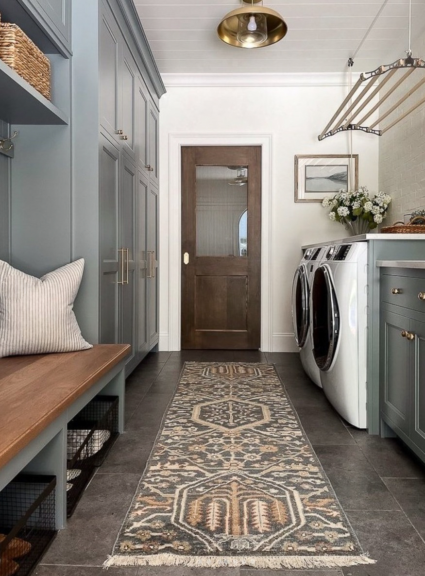 a cottage style laundry room with a statement runner and blue grey paint