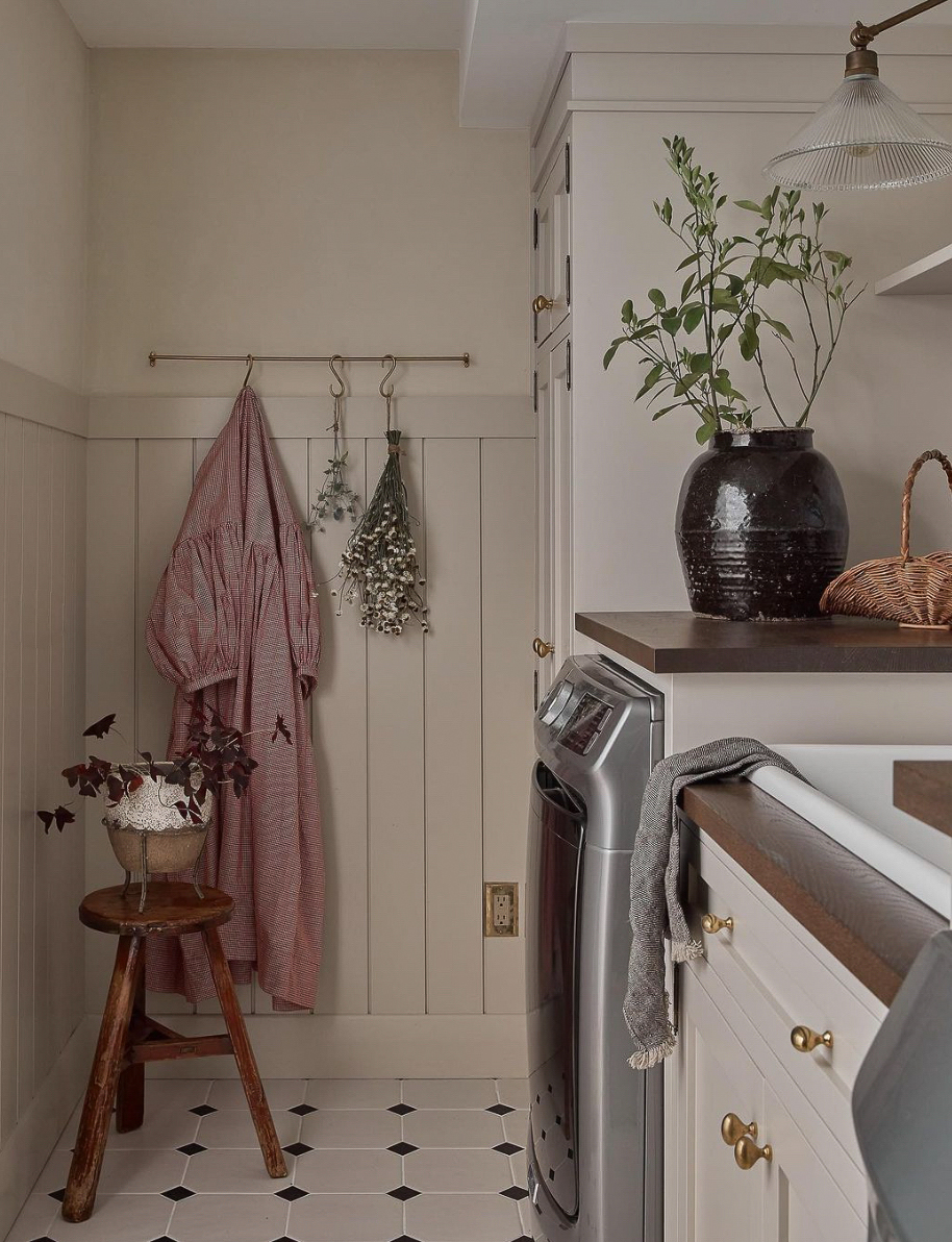 a cottage style laundry room with vintage flair