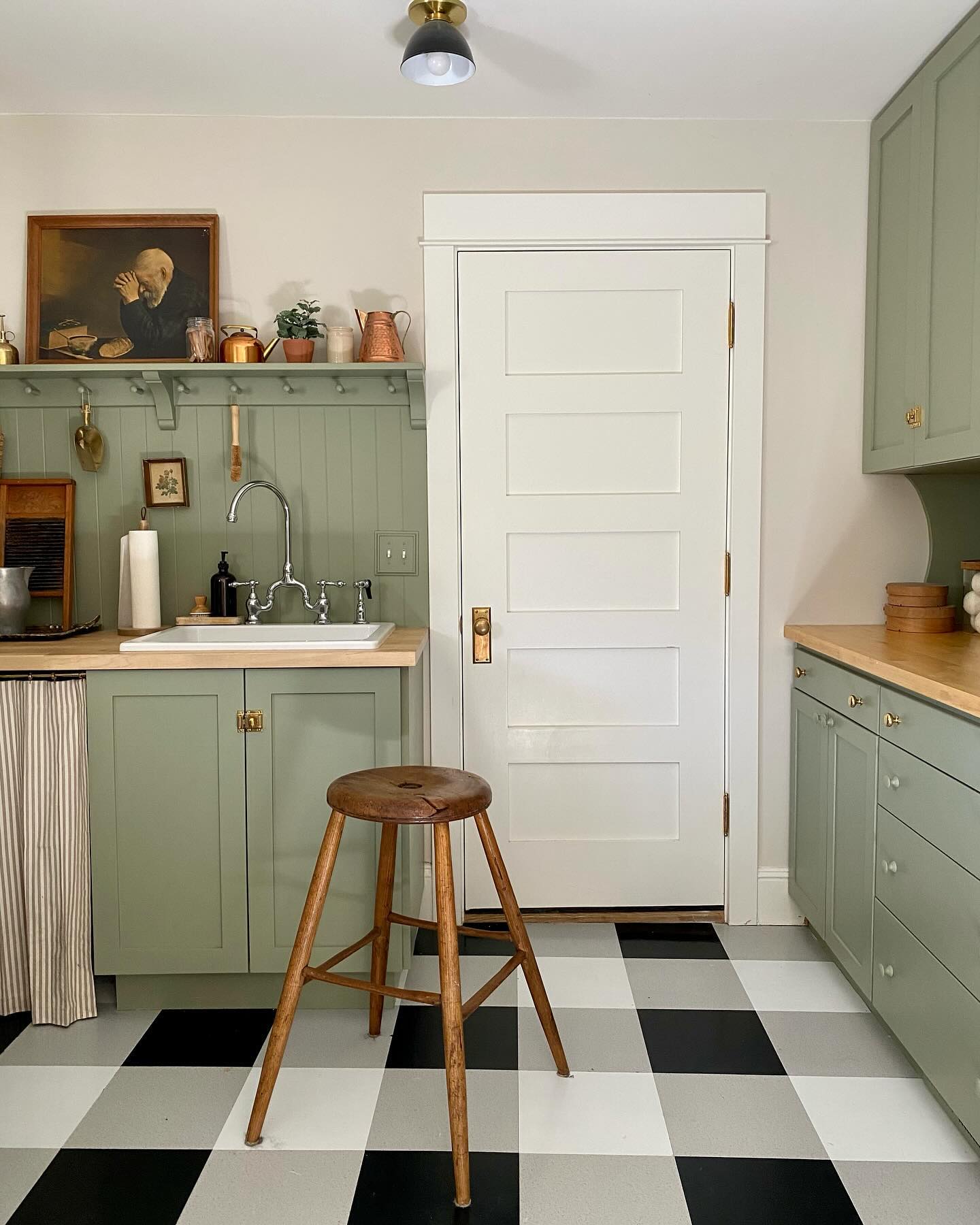 a cottage style laundry room with bright green paint and vintage decor