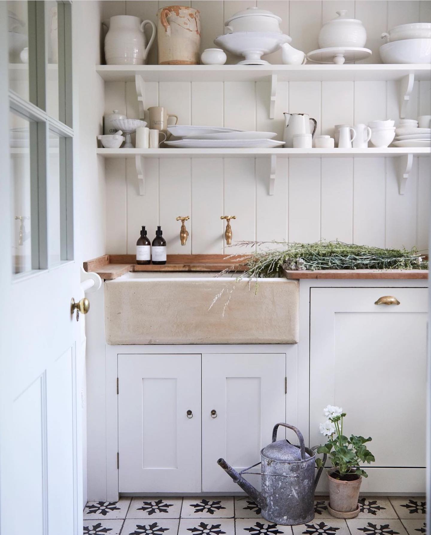 a white cottage style laundry room with farmhouse touches