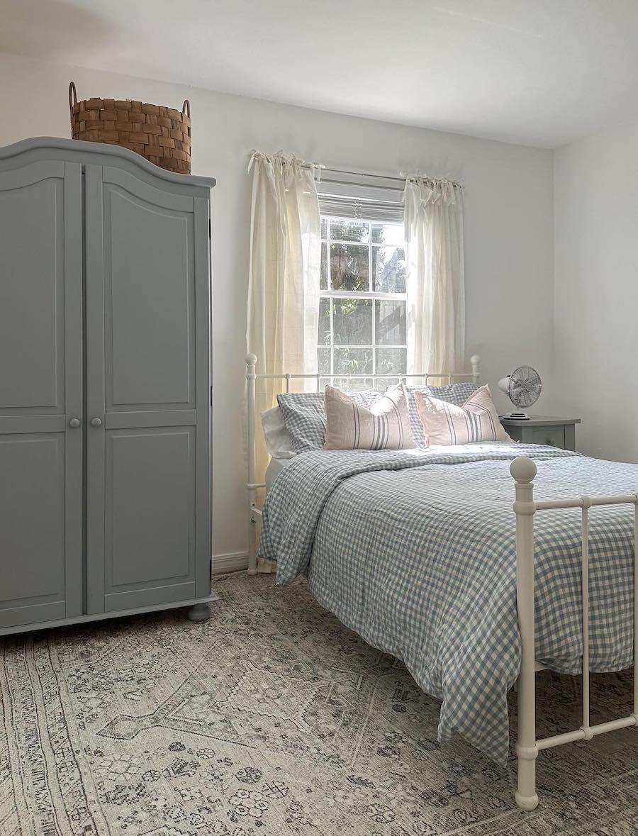 a cottagecore bedroom with blue and ivory tones