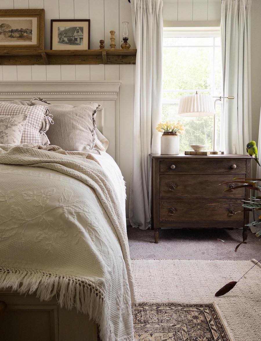 a cottagecore bedroom with dark wood and ivory shiplap walls