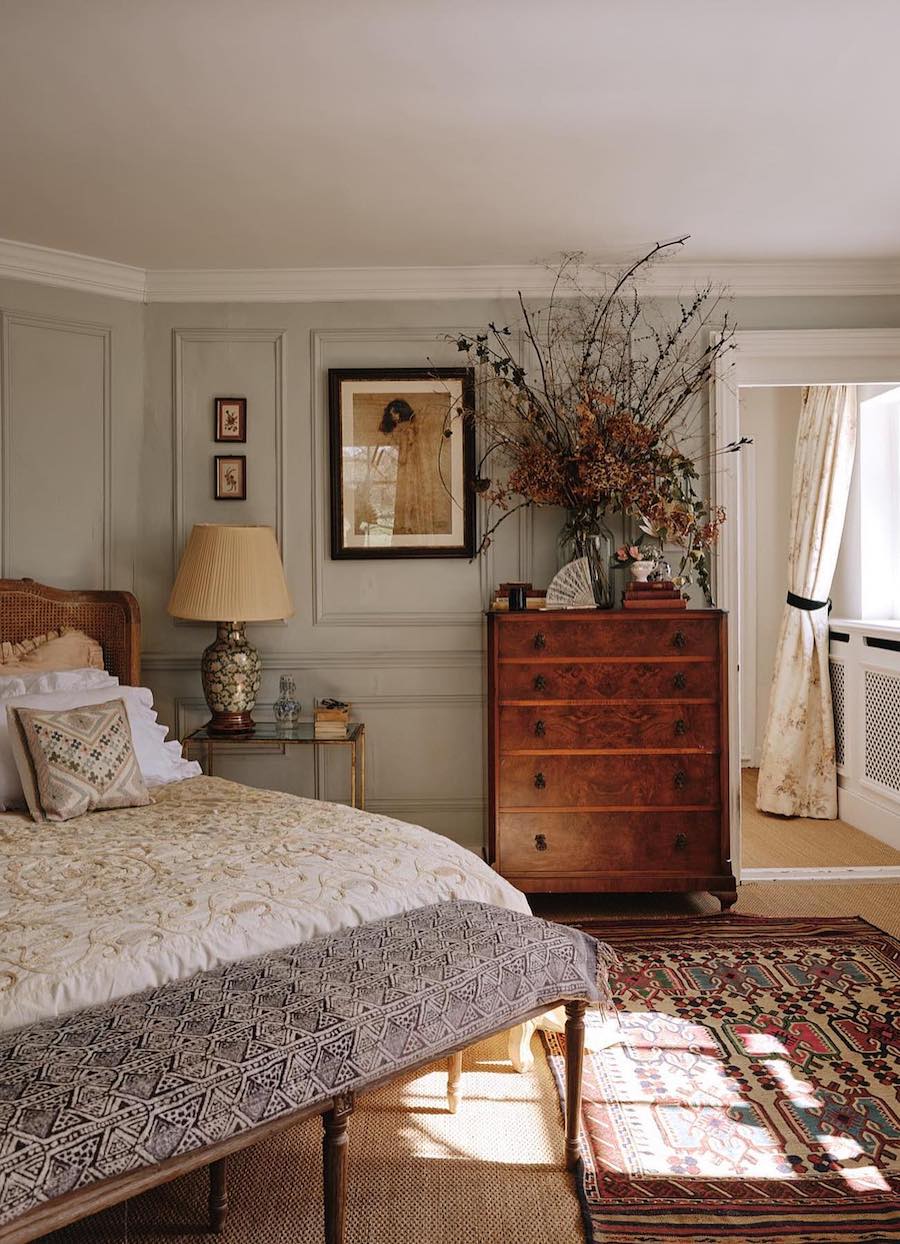 a cottagecore bedroom with warm wood and traditional furnishings