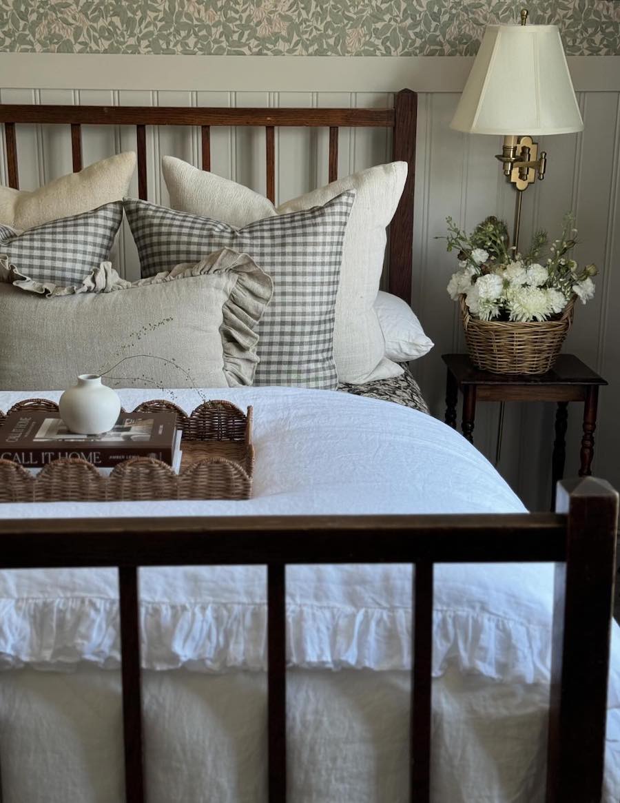 a cottagecore bedroom with vintage bedding and decor