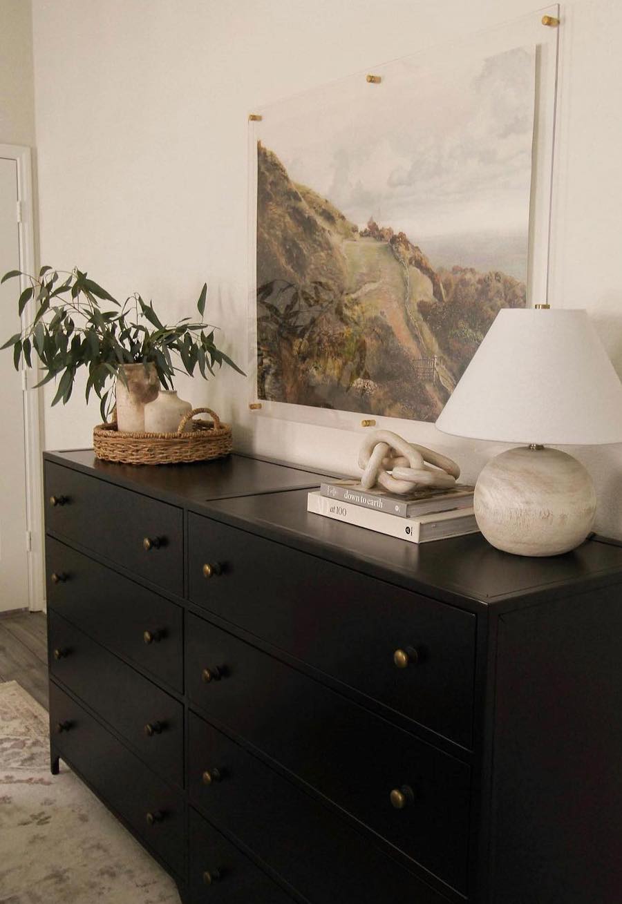 an entryway with a black dressed and natural boho decor