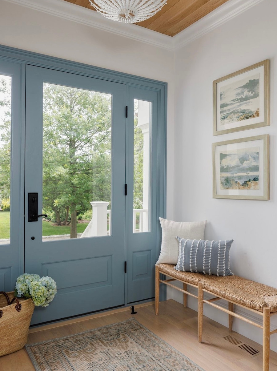 an entryway with blue, tan, and white decor and coastal flair