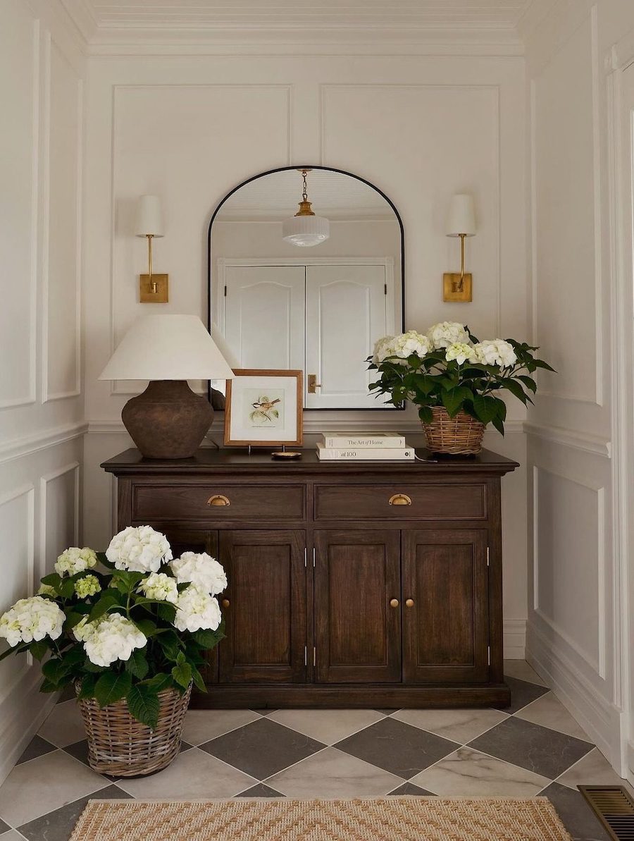 an entryway with an espresso dress and white florals