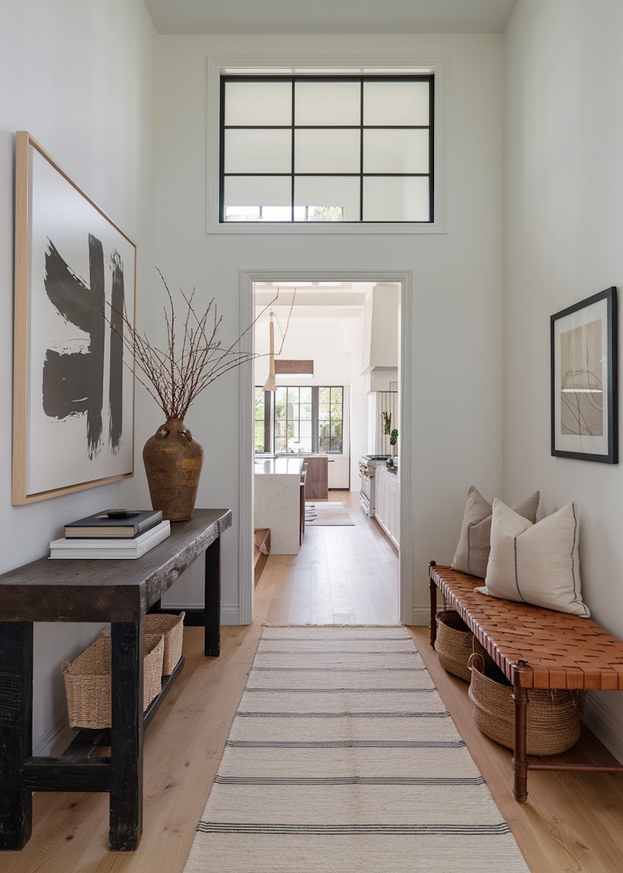 an entryway with camel, black, and white tones