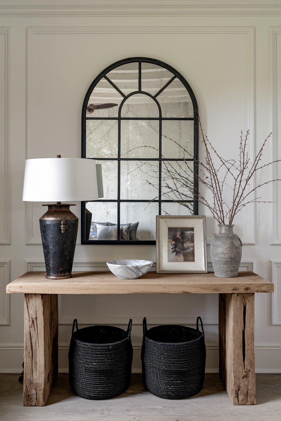 an entryway with black and cool toned wood