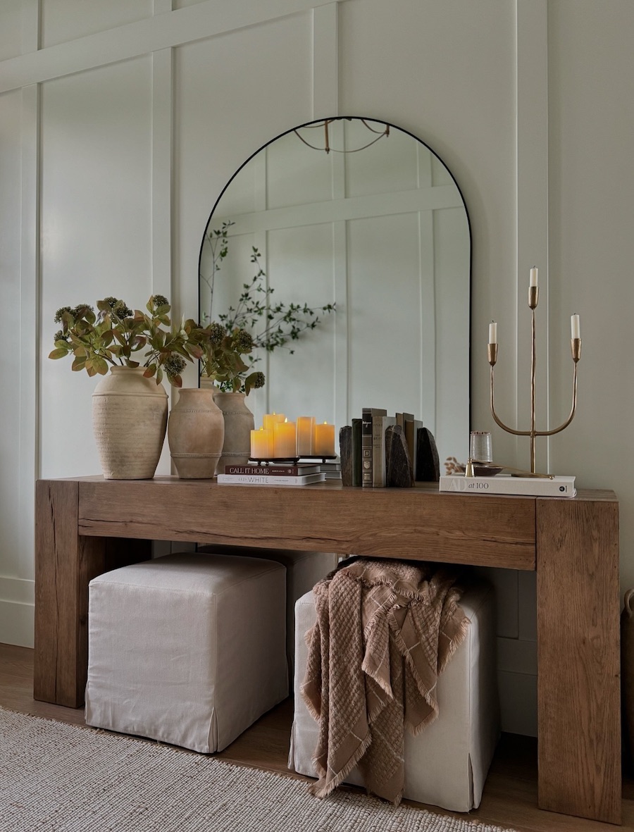 an entryway with a large wood table and modern decor