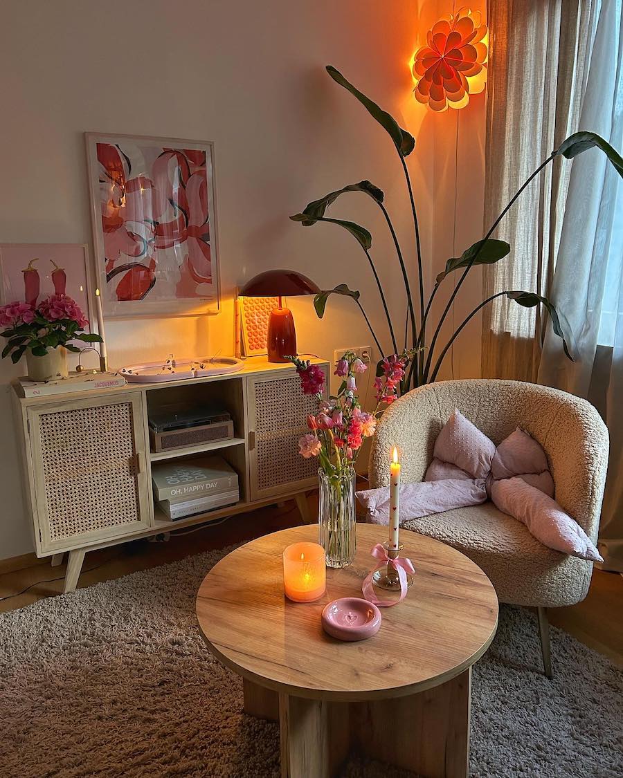 a living room featuring pink tones and eclectic decor