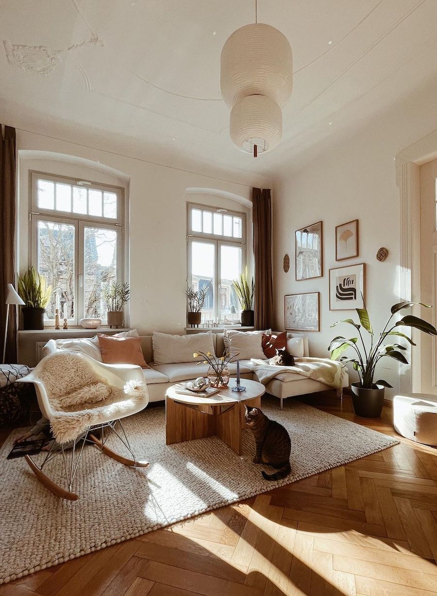 a living room featuring white and tan boho decor