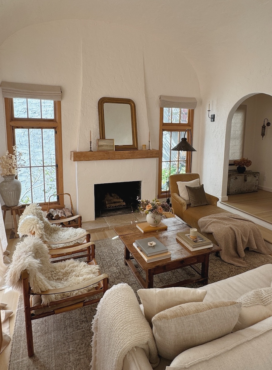 a living room featuring warm neutral tones with plenty of pillows and blankets