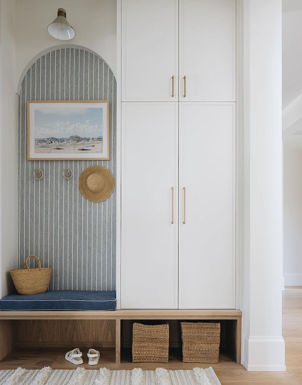 a mudroom featuring coastal decor and hidden storage