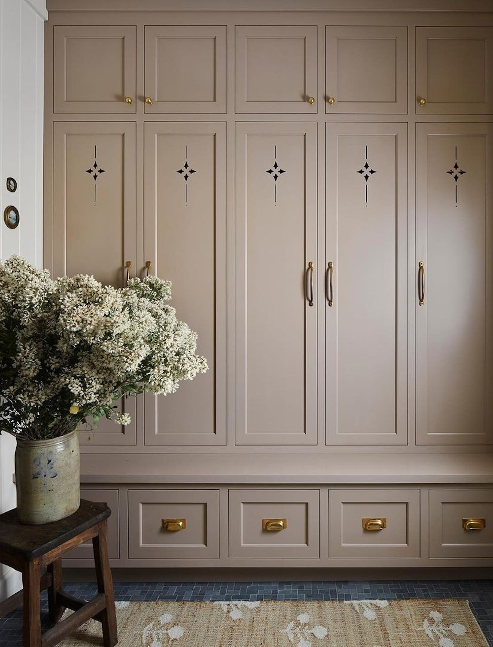 a mudroom featuring elegant decor and details and hidden storage